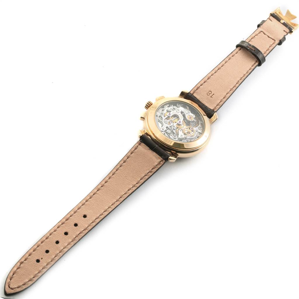 The Vacheron Constantin Historiques 47101/1 Men's Yellow Gold Silver Dial 47101/1 Men's Yellow Gold Silver Dial model is shown from the back, displaying its intricate mechanical movement and leather strap.