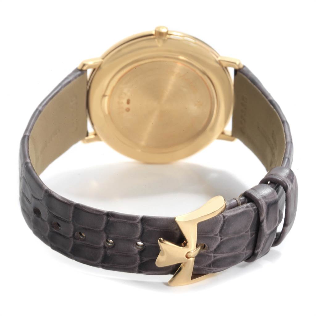 The image shows the back of a Vacheron Constantin Patrimony 31160 Men's Yellow Gold White Dial 31160 Men's Yellow Gold White Dial watch and its leather strap with a gold buckle.