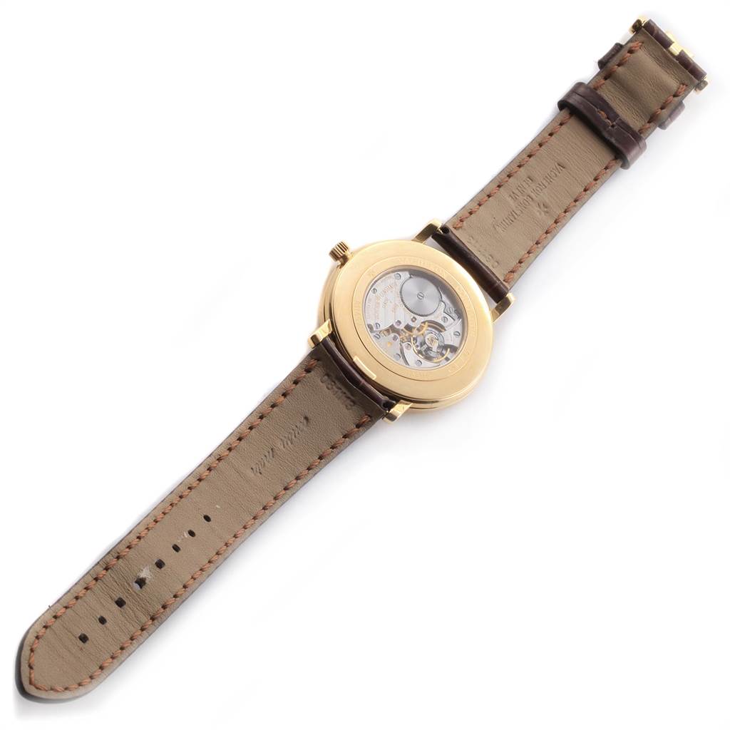 The image shows the back side of a Vacheron Constantin Patrimony 31160 Men's Yellow Gold Silver Dial 31160 Men's Yellow Gold Silver Dial watch, highlighting its open case back and leather strap.