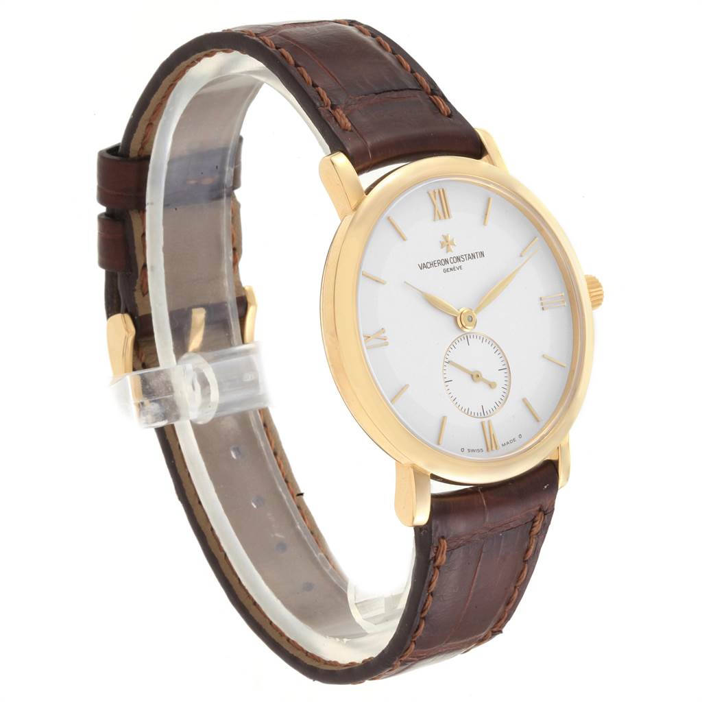 The image shows a side angle view of the Vacheron Constantin Patrimony 31160 Men's Yellow Gold Silver Dial 31160 Men's Yellow Gold Silver Dial watch, highlighting its gold case, white dial, and brown leather strap.