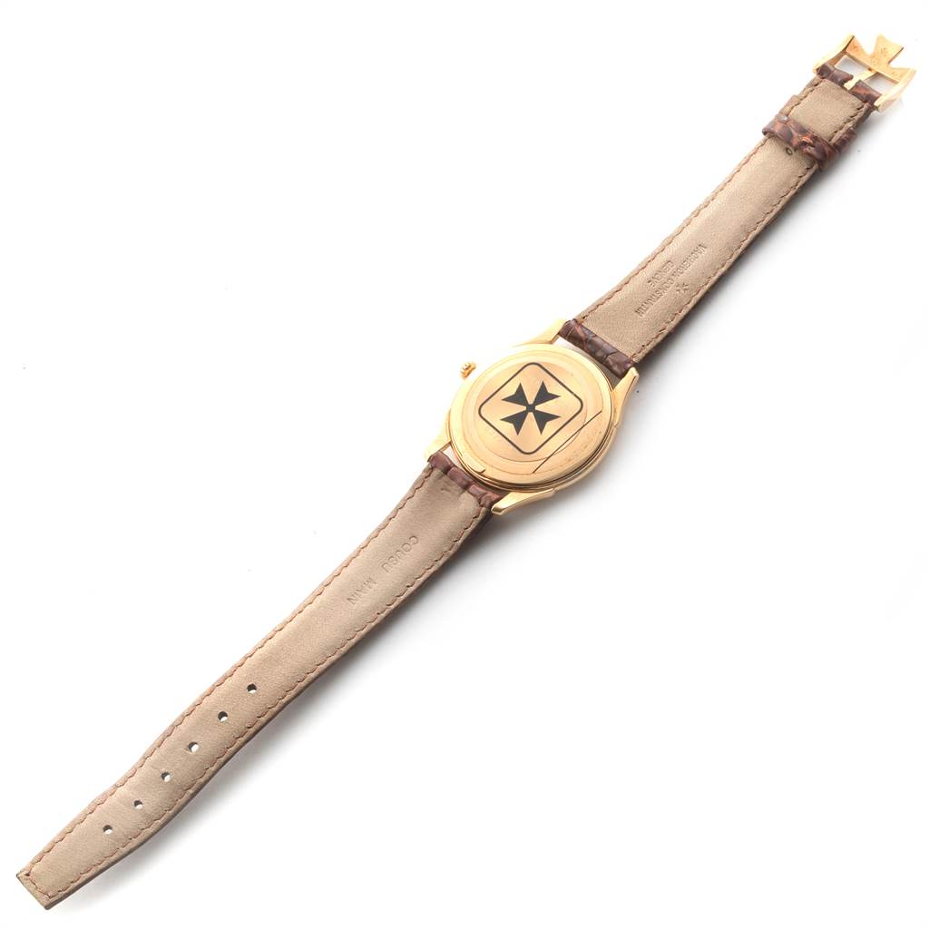 This image shows a Vacheron Constantin Historiques 92239 Men's Yellow Gold Silver Dial 92239 Men's Yellow Gold Silver Dial model watch viewed from the back, displaying the case back and leather strap.