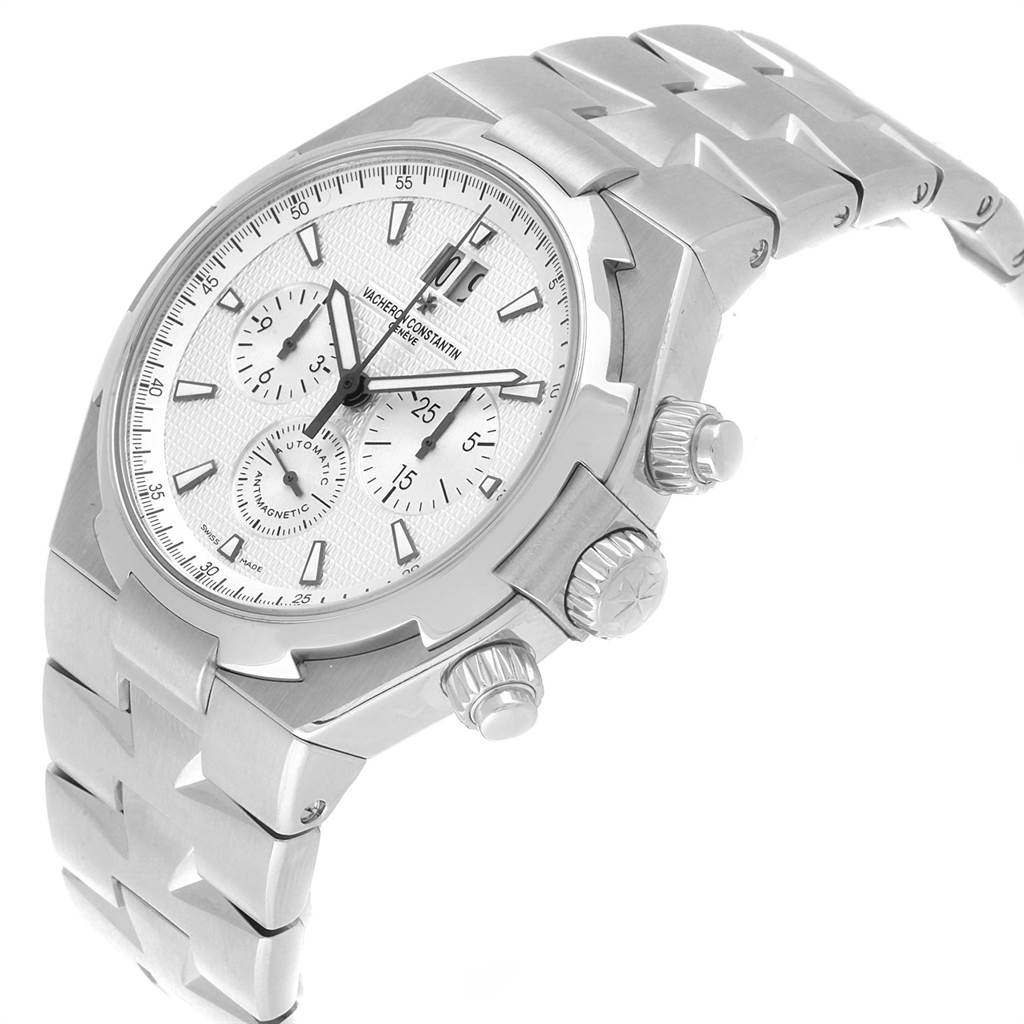 The image shows a side angle of the Vacheron Constantin Overseas 49150 Men's Stainless Steel Silver Dial 49150 Men's Stainless Steel Silver Dial watch, featuring its dial, crown, pushers, and bracelet.