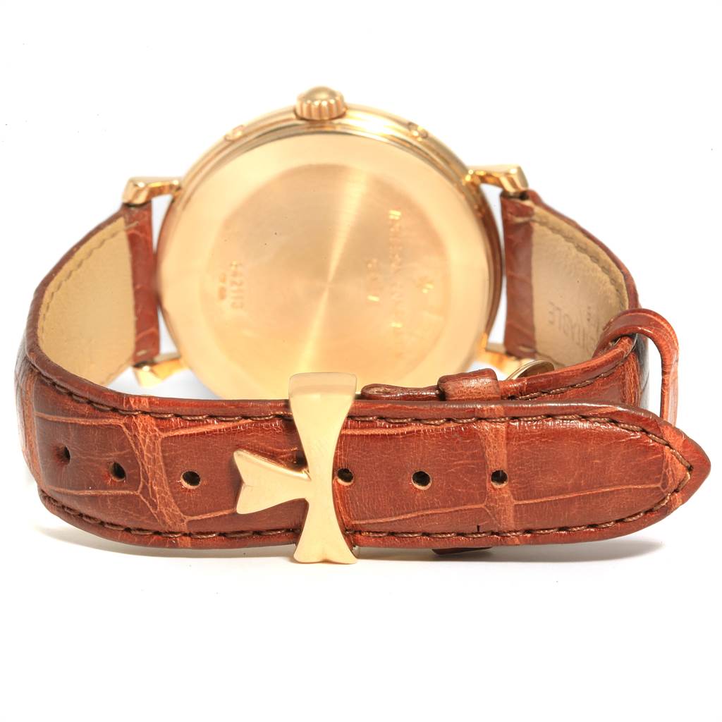This image shows the back view of a Vintage Vacheron Constantin watch, focusing on the case back and leather strap with a cross-shaped buckle.