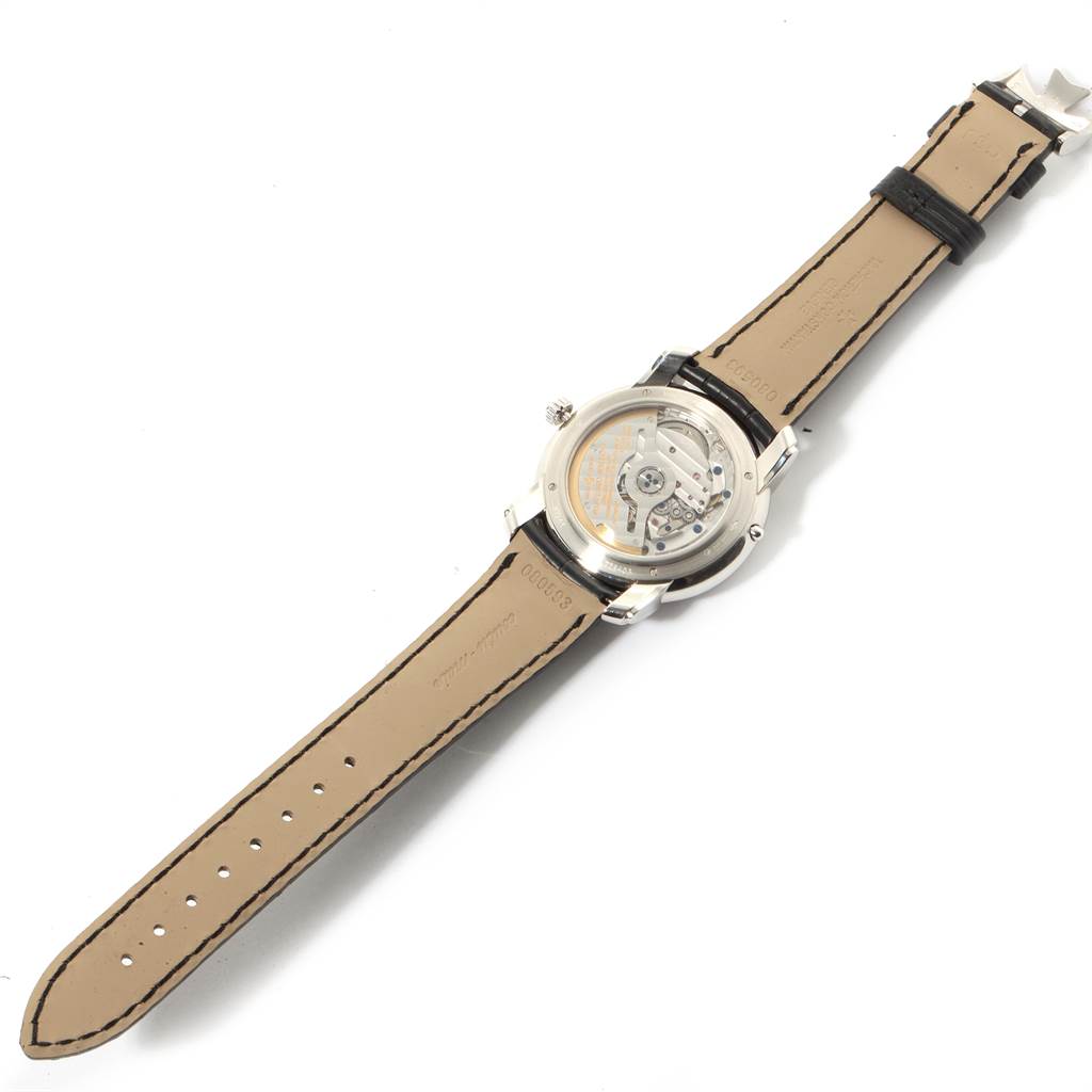 The image shows the back view of a Vacheron Constantin Patrimony 47245 Men's Platinum Black Dial 47245 Men's Platinum Black Dial watch, revealing its movement and leather strap.