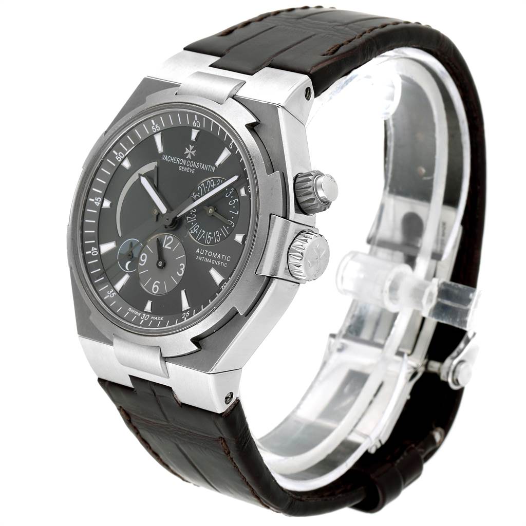 This image shows a Vacheron Constantin Overseas 47450/000W-9511 Men's Stainless Steel Grey Dial 47450/000W-9511 Men's Stainless Steel Grey Dial watch at a three-quarter angle, displaying the face, side buttons, and leather strap.