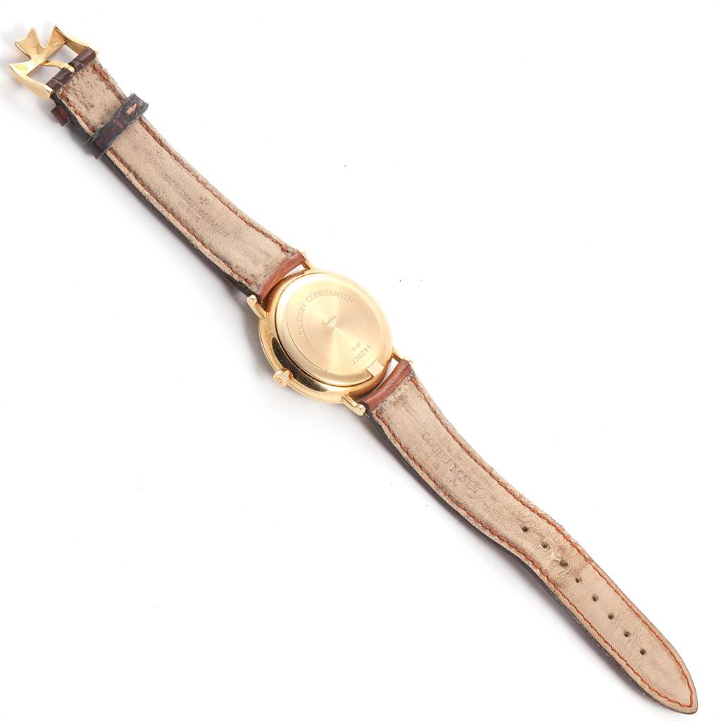 The image shows the back view of a Vacheron Constantin Patrimony 42002 Men
s Yellow Gold White Dial 42002 Men
s Yellow Gold White Dial watch with its leather strap and buckle.