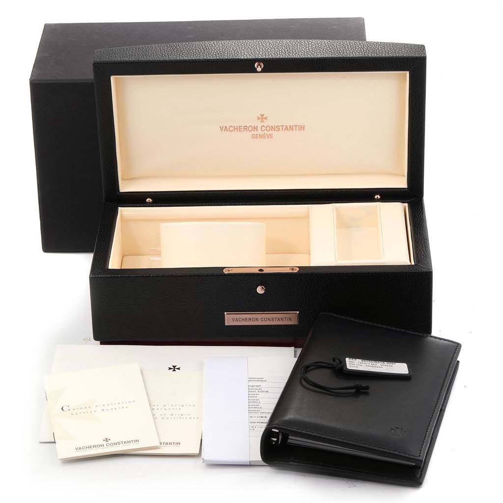The image shows an open box and accessories for the Vacheron Constantin Overseas 49150.B01A.9097 Men's Stainless Steel Black Dial 49150.B01A.9097 Men's Stainless Steel Black Dial model, including documents, a leather pouch, and packaging.