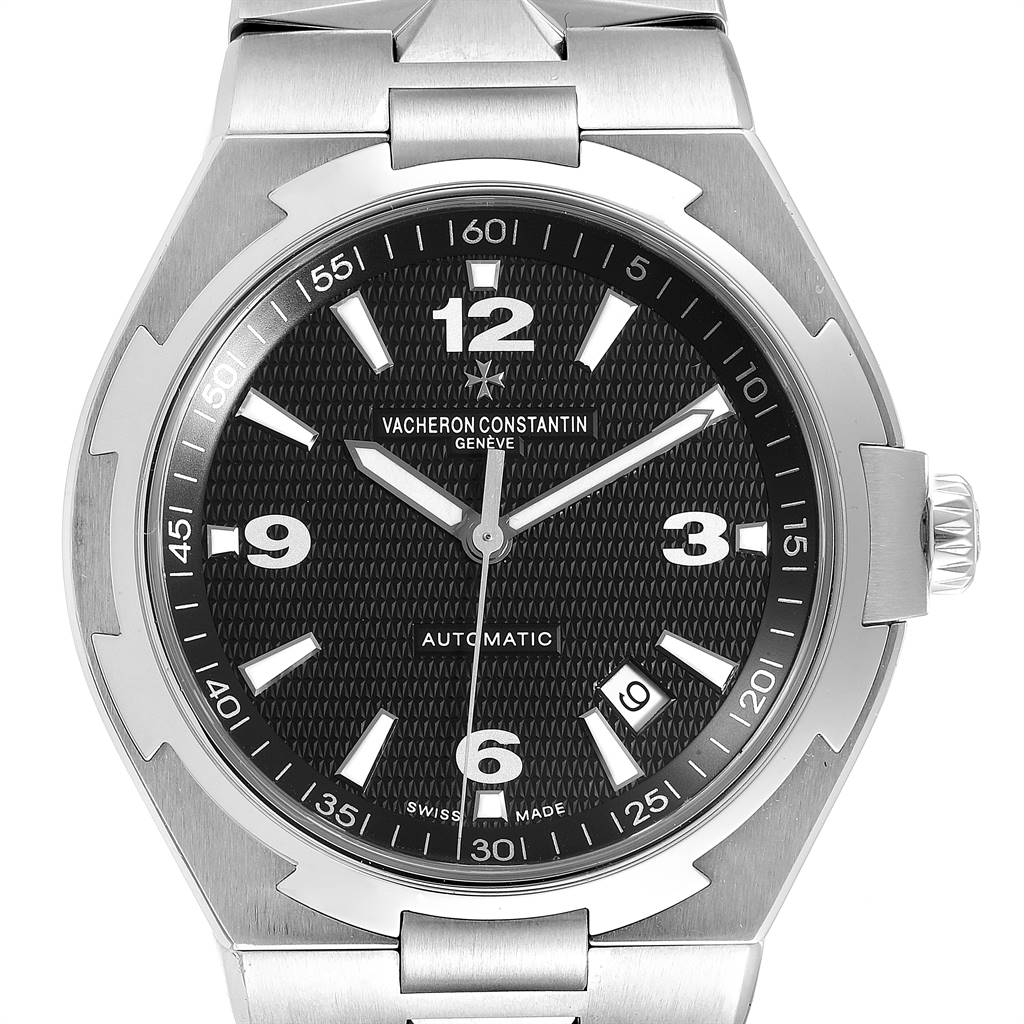 The image shows a front view of a Vacheron Constantin Overseas 47040/B01A-9094 Men
s Stainless Steel Black Dial 47040/B01A-9094 Men
s Stainless Steel Black Dial model watch, highlighting its stainless steel case, black textured dial, and bracelet.