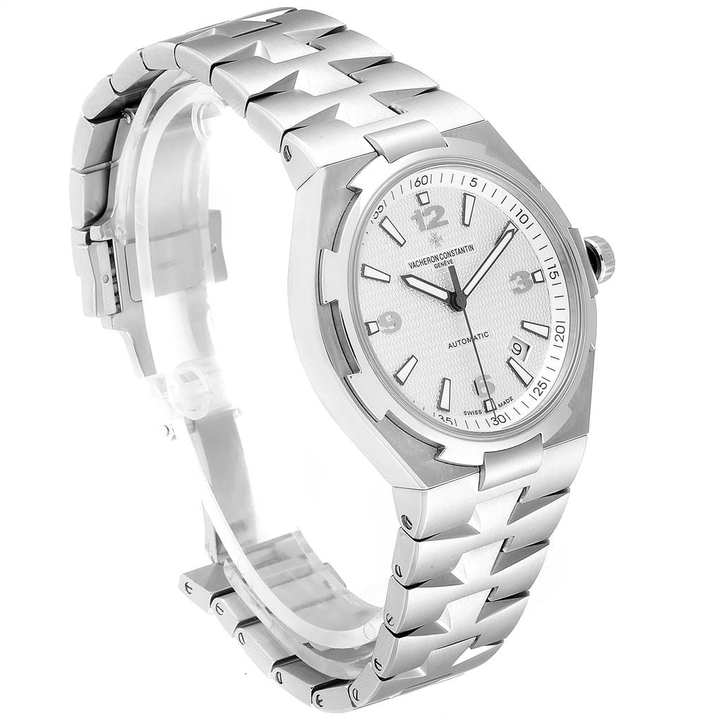 This Vacheron Constantin Overseas 47040B01A-9093 Men's Stainless Steel Silver Dial 47040B01A-9093 Men's Stainless Steel Silver Dial watch is shown at an angle showcasing its silver bracelet, watch face, and crown.