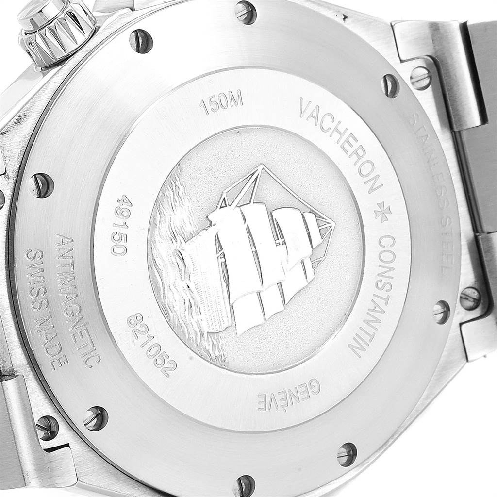 The image shows the engraved back case of a Vacheron Constantin Overseas 49150 Men's Stainless Steel Silver Dial 49150 Men's Stainless Steel Silver Dial watch, displaying a ship and various inscriptions.