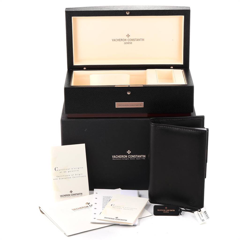 This image shows a Vacheron Constantin Overseas 49150 Men's Stainless Steel Silver Dial 49150 Men's Stainless Steel Silver Dial watch box, a black case, manuals, and tags from a front-facing angle.