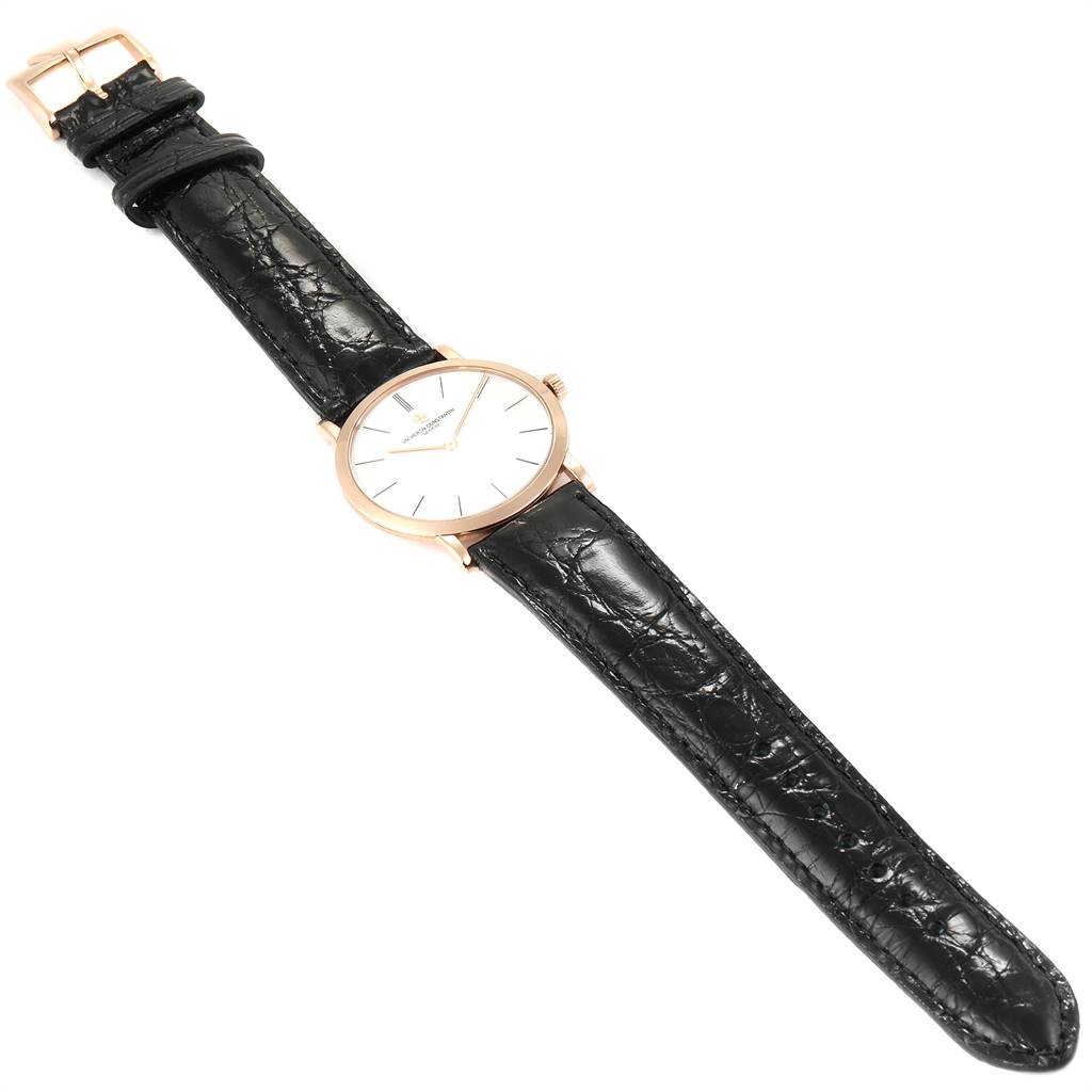 The Patrimony model by Vacheron Constantin is shown from a top-down angle, featuring a black leather strap and a round dial.