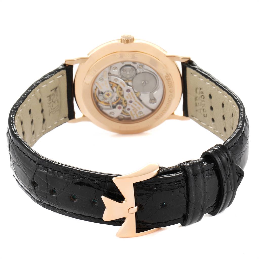 The image shows the back view of the Vacheron Constantin Patrimony 33093/3 Men's Rose Gold White Dial 33093/3 Men's Rose Gold White Dial watch, highlighting the movement and leather strap with a distinctive buckle.