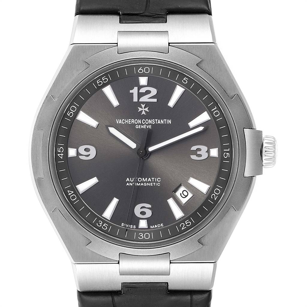 The image shows a Vacheron Constantin Overseas 47040/000W-9500 Men's Stainless Steel Black Dial 47040/000W-9500 Men's Stainless Steel Black Dial watch, featuring its dial, hands, crown, and part of the strap, viewed from the front.