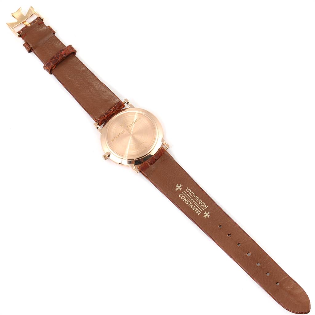The image shows the Vacheron Constantin Patrimony 33093/1 Men's Rose Gold White Dial 33093/1 Men's Rose Gold White Dial watch from the back, highlighting the case back and brown leather strap.