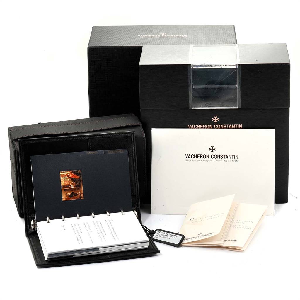 The image shows the packaging, booklets, and accessories for the Vacheron Constantin Overseas 49150 Men's Stainless Steel Silver Dial 49150 Men's Stainless Steel Silver Dial model watch.