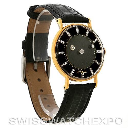The Jaeger LeCoultre Vintage Yellow Gold Black Dial Yellow Gold Black Dial watch is shown at an angled side view, displaying its black leather strap, gold casing, and black dial with diamond markers.