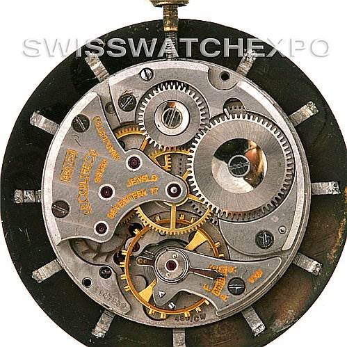 This image shows the movement mechanism of a vintage Jaeger LeCoultre watch, viewed from the back with its intricate gears and components exposed.