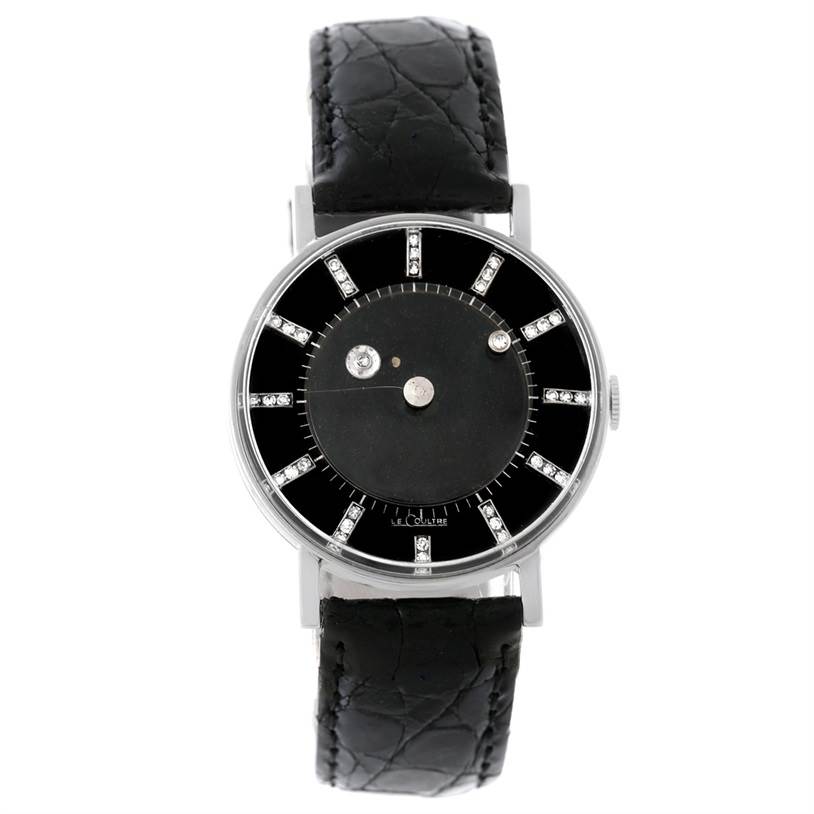 The image shows a front view of a Vintage Vacheron Constantin watch, featuring a black dial, diamond hour markers, and a black leather strap.