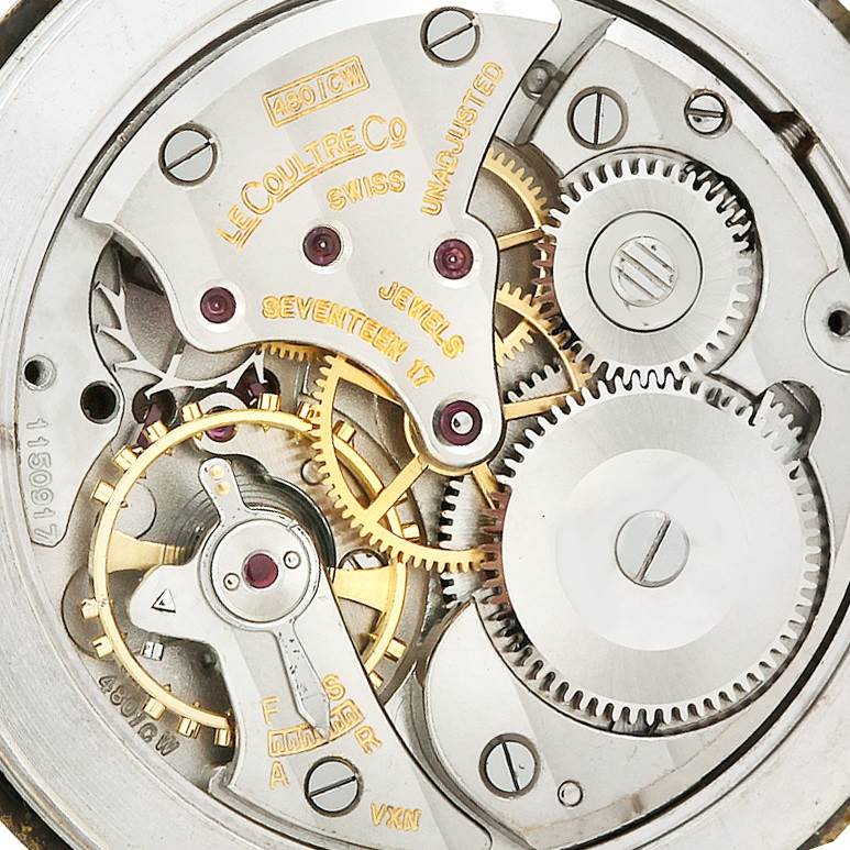 The image shows the intricate inner mechanics and gears of a Vintage Vacheron Constantin watch movement.
