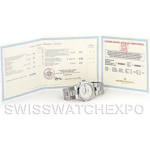 The image shows a Vacheron Constantin Overseas 42042 Men's Stainless Steel Silver Dial 42042 Men's Stainless Steel Silver Dial watch positioned in front of its open certification papers.