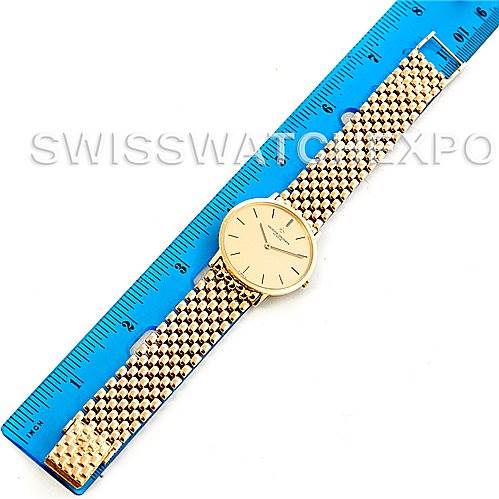 The image shows a Vintage Vacheron Constantin watch laid flat next to a blue ruler, displaying its gold bracelet and face.