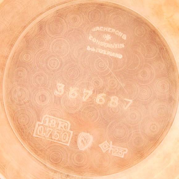 The image shows the inside case back of a Vintage Vacheron Constantin watch, revealing engravings and hallmarks.
