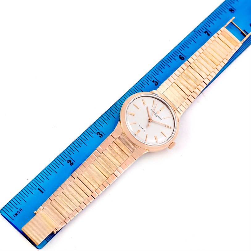 This image features a flat-lay view of a Vintage Vacheron Constantin watch, showing the face, case, and band, measured alongside a blue ruler.