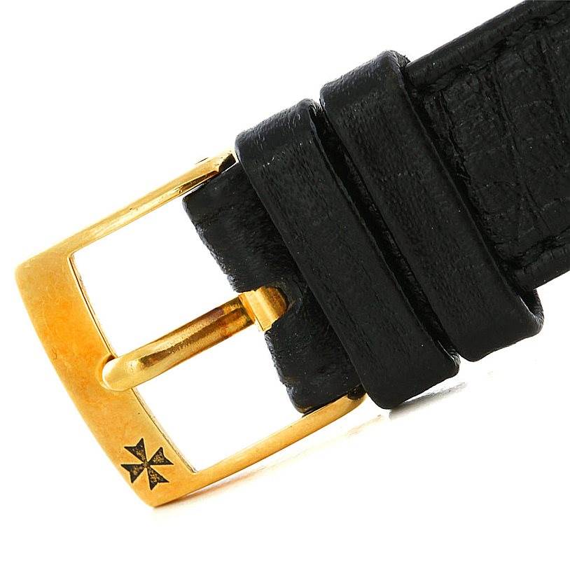 This image shows a close-up angle of the gold buckle and black leather strap loop on a Vintage Vacheron Constantin watch.