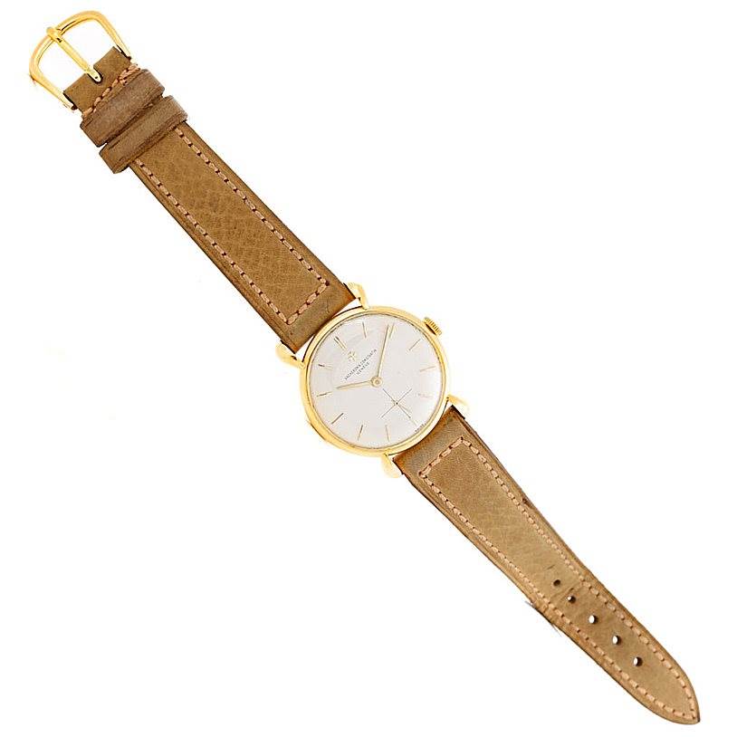 The image shows a top-down view of a Vintage Vacheron Constantin watch with a brown leather strap and a gold case.
