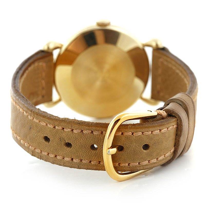 The image shows the back view of a Vintage Vacheron Constantin watch, highlighting its leather strap and gold buckle.