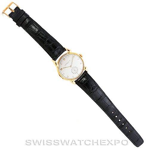 The image shows a top-down view of a Vintage Vacheron Constantin watch with a black leather strap and a gold case.