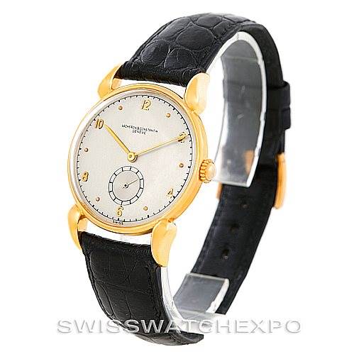 The image shows a vintage Vacheron Constantin watch at a three-quarter angle, highlighting its gold case, white dial, and black leather strap.