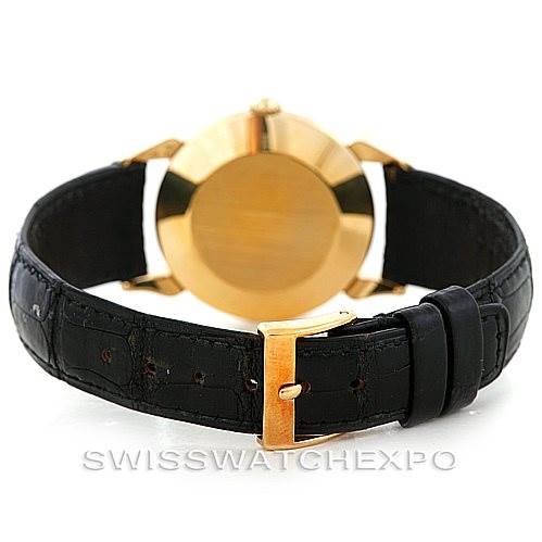 The image shows the back view of a Vintage Vacheron Constantin watch, highlighting its gold case and black leather strap with a gold buckle.