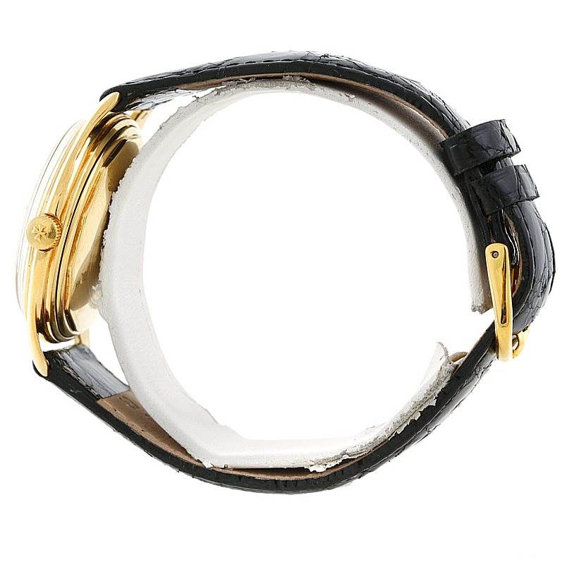 The image shows a side view of a Vintage Vacheron Constantin watch, highlighting its gold case and black strap.