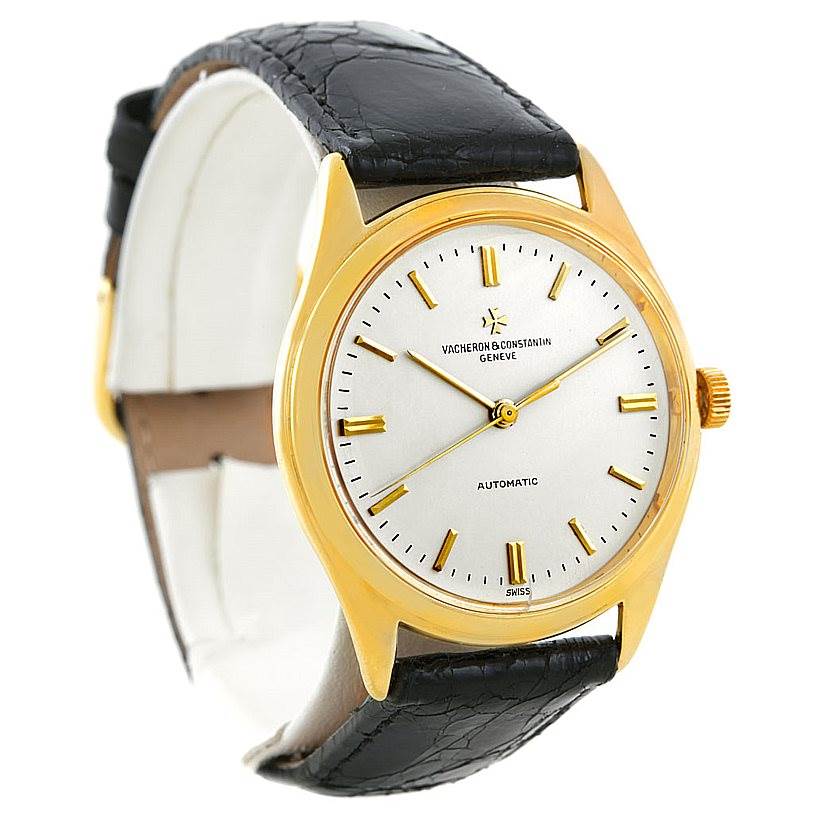 The image shows a Vacheron Constantin Vintage 4870 Men's Yellow Gold Silver Dial 4870 Men's Yellow Gold Silver Dial watch from an angled side view, highlighting the gold case, dial, and leather strap.