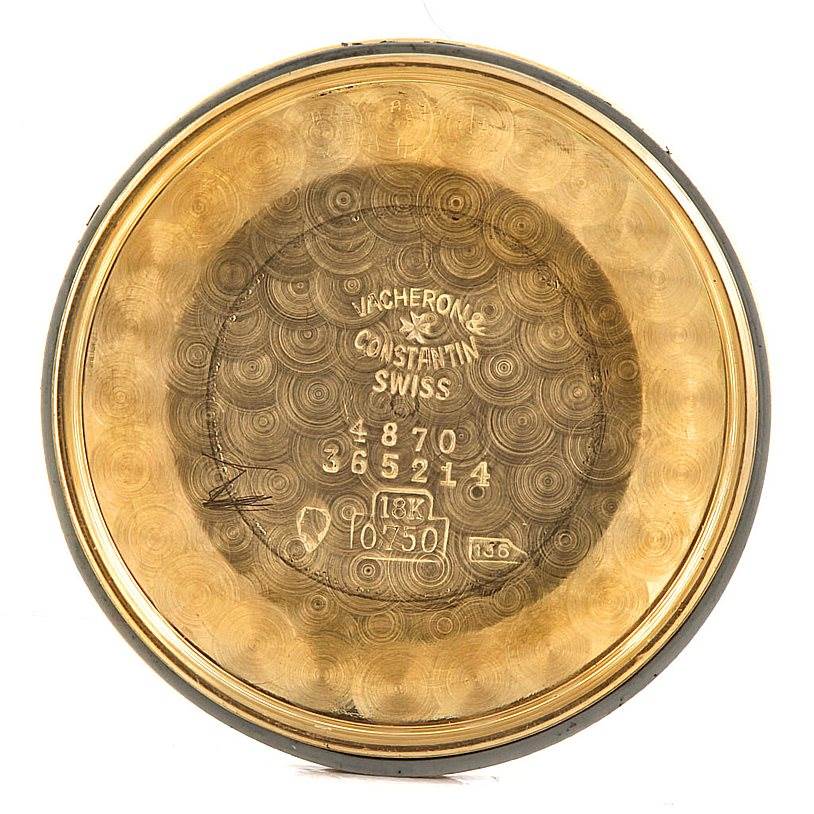 This image shows the inner case back of a Vintage Vacheron Constantin watch, displaying serial numbers and hallmark markings.