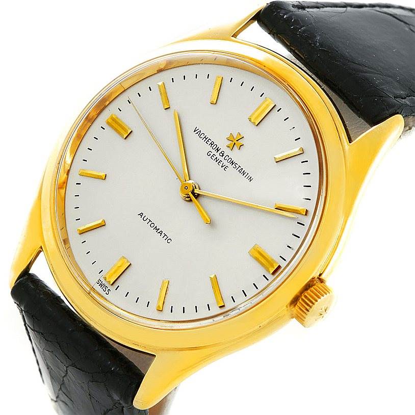 This image shows a top-down view of a vintage Vacheron Constantin watch featuring a gold case, white dial, and black leather strap.