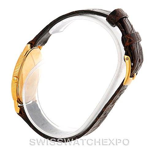 The image shows a side view of a Vintage Vacheron Constantin watch, highlighting its gold case and brown leather strap with a buckle.