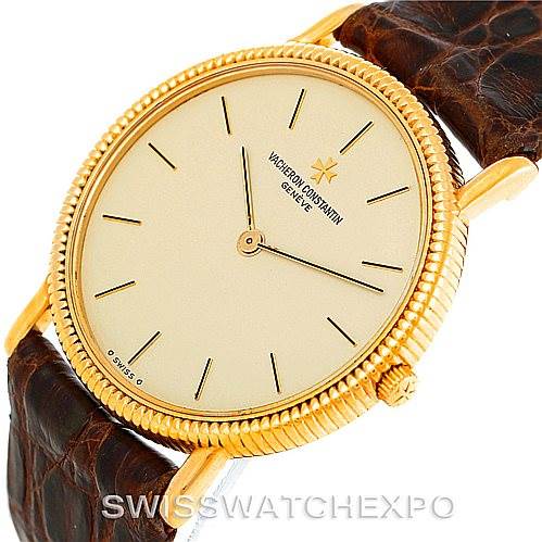 The image shows a Vacheron Constantin Vintage 33076 Men's Yellow Gold Beige Dial 33076 Men's Yellow Gold Beige Dial model watch at a slightly tilted angle, displaying the gold case, crown, and brown leather strap.