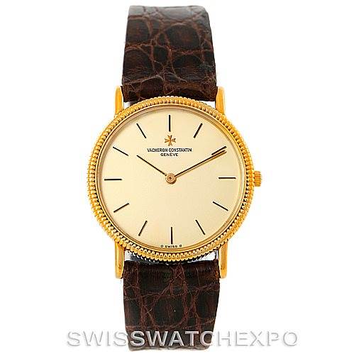 This image shows the front view of a Vintage Vacheron Constantin watch with a gold case and brown leather strap.