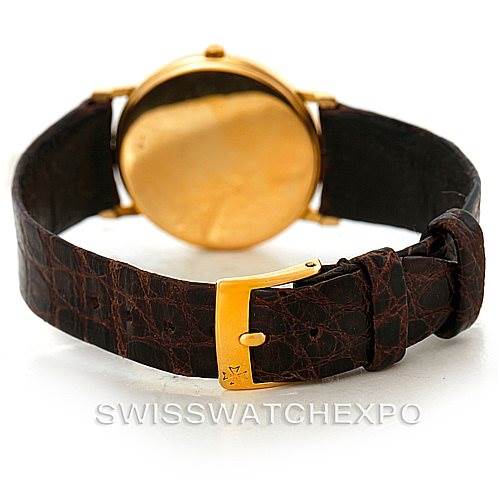 The image shows the back and strap of a Vintage Vacheron Constantin watch, featuring a gold buckle and a brown leather band.