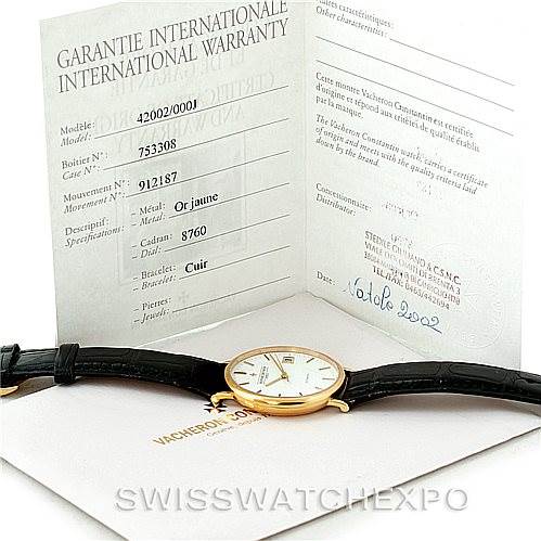 The image shows a Vacheron Constantin Vintage 42002 Men's Yellow Gold White Dial 42002 Men's Yellow Gold White Dial watch and its international warranty card, displayed at an angle to show full details.