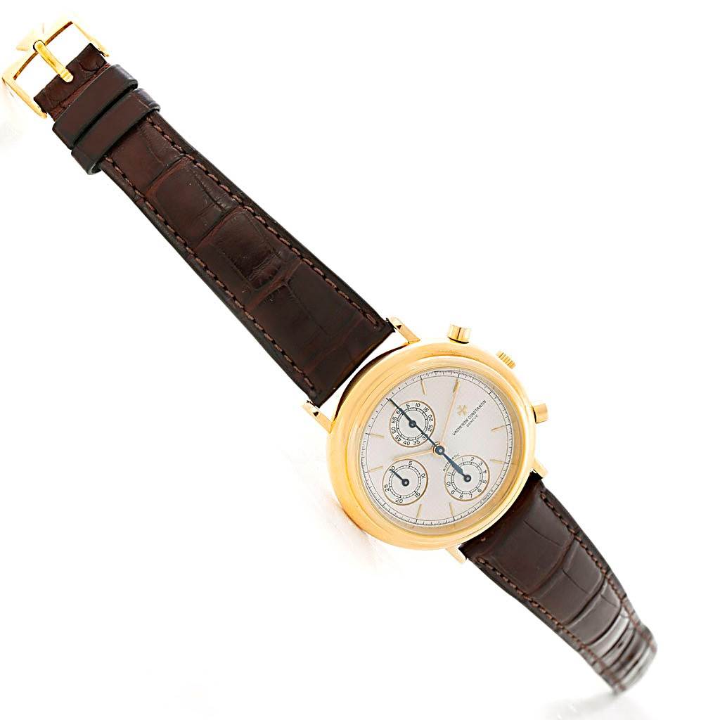 The image shows a vintage Vacheron Constantin watch at an angled top view, highlighting its face, gold case, and brown leather strap.