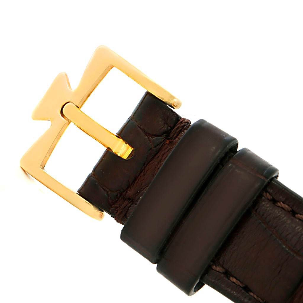 The image shows a close-up view of the gold buckle and brown leather strap of a Vintage Vacheron Constantin watch.