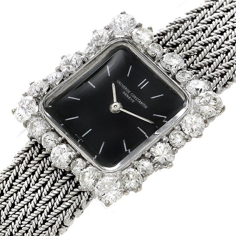 This image shows a close-up of a Vintage Vacheron Constantin watch with a square face, black dial, and diamond-encrusted bezel, including the woven strap.