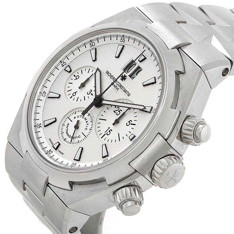 The image shows a Vacheron Constantin Overseas 49150 Men's Stainless Steel Silver Dial 49150 Men's Stainless Steel Silver Dial watch at an angled view, highlighting the face, crown, subdials, bezel, and part of the bracelet.