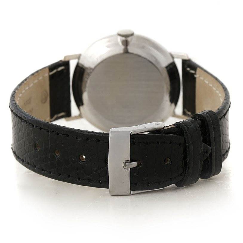 This image shows the back of a Vintage Vacheron Constantin watch, focusing on the case back and black leather strap with buckle.