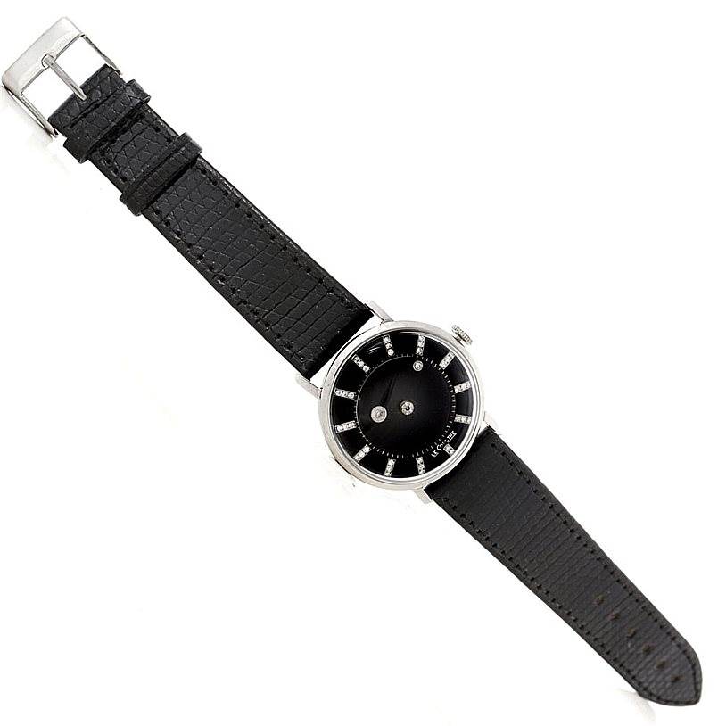 The image shows a bird
s-eye view of a Vintage Vacheron Constantin watch with a black leather strap and a minimalist black dial.