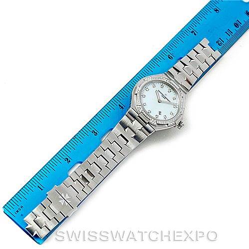 The image shows an overhead view of a Vacheron Constantin Overseas 25750 Women's Stainless Steel Mother of Pearl Dial 25750 Women's Stainless Steel Mother of Pearl Dial watch with a blue ruler for scale.